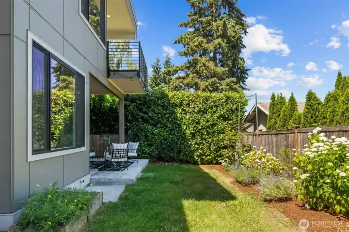Step outside to a private, beautifully landscaped backyard that combines lush greenery with easy-care living.