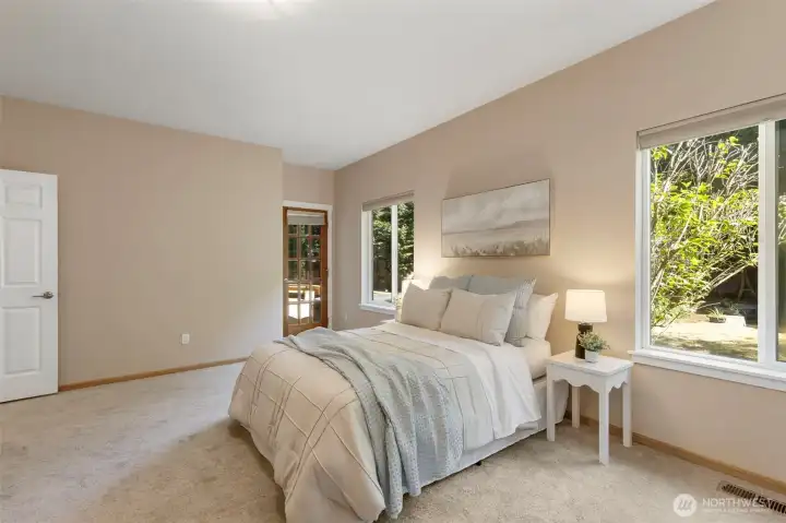 Primary bedroom with access to back deck and hot tub