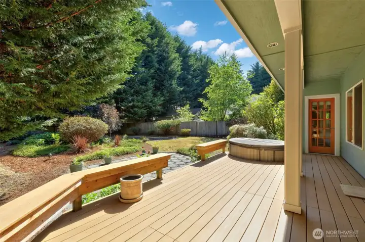 Partial covered back deck leads to fully fenced backyard