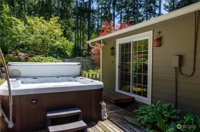 hot tub with access from patio and primary