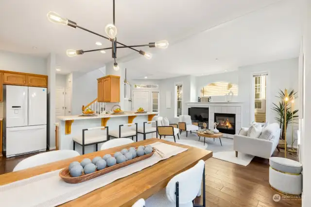 Bright and airy, this dining area features modern lighting and flows seamlessly into the kitchen for easy entertaining.