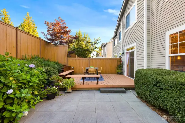 A peaceful retreat awaits you in this well-manicured backyard, offering a charming deck and plenty of space for outdoor fun.