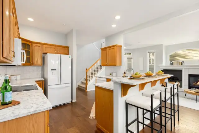 Gather around the kitchen’s breakfast bar or enjoy a meal in the adjacent dining area—perfect for hosting or everyday living.