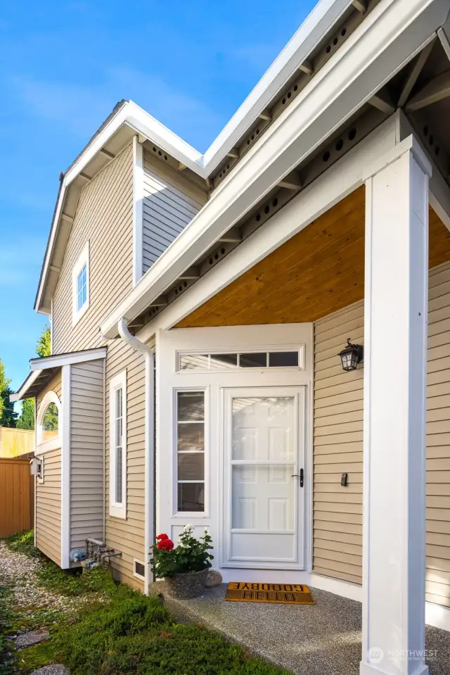 A warm and welcoming entrance sets the tone for this beautiful home, with a covered front porch and ample natural light.