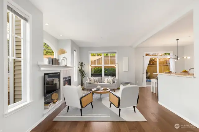 Light-filled and inviting, this living room boasts large windows that overlook the backyard, creating a perfect space to relax and unwind.