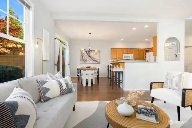 Light-filled and inviting, this living room boasts large windows that overlook the backyard, creating a perfect space to relax and unwind.