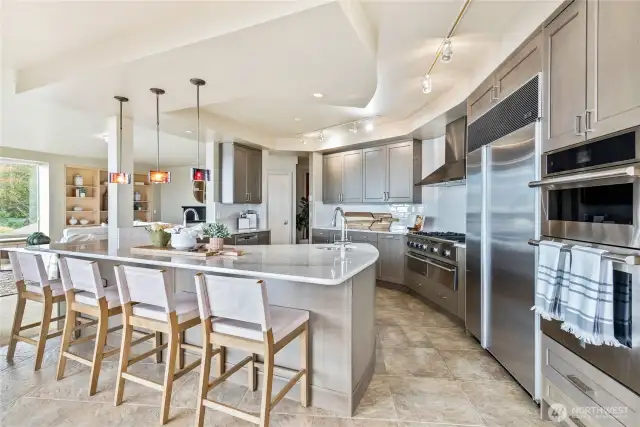 View of open floor plan kitchen off of Family Room with walls of windows encompassing panoramic views!