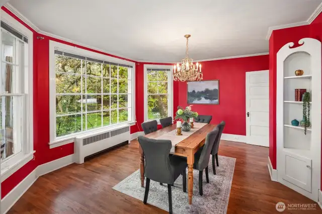 Formal dining room transforms with the season. The established landscaping and partial water views create the perfect space to gather.