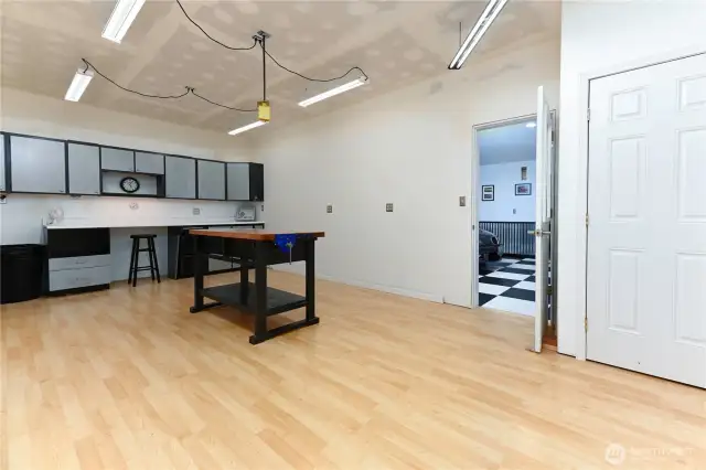The workshop room offers endless possibilities with its thoughtfully designed layout, providing ample space for projects, storage, and creative endeavors.