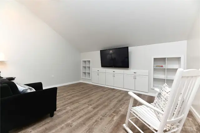 The family room in the detached garage/shop is a fantastic theater room, pre-wired and ready for your entertainment setup, making it the ultimate space for movie nights and gatherings.