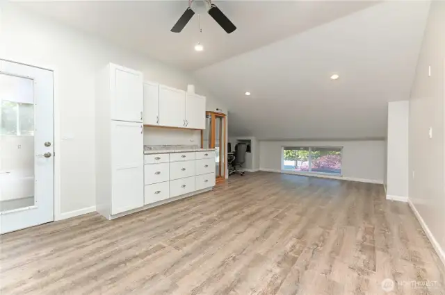 This large office space, located above the garage, offers the perfect setting for a home office. Dual staircases provide added privacy, separating this room from the main living quarters.