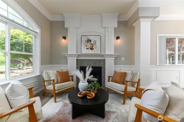 The living room is ideal for both everyday living and entertaining. It’s light and bright, featuring large windows that seamlessly blend the outdoors with the indoors.