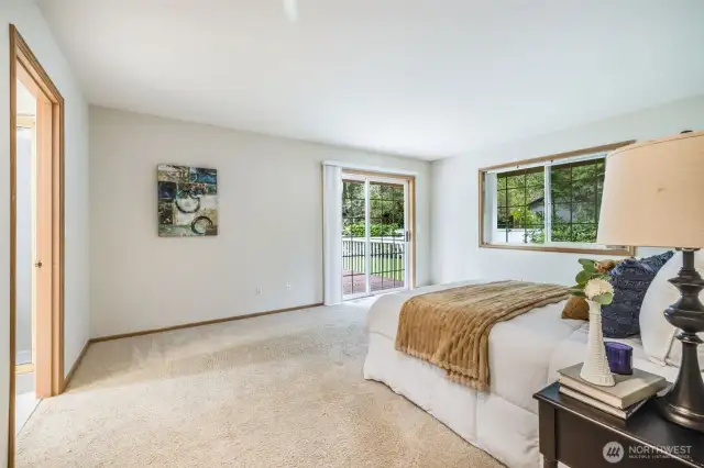 Primary bedroom with access to rear deck.