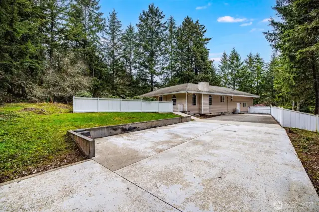 Poured concrete driveway on side of property ready for a new detached garage or rv parking.
