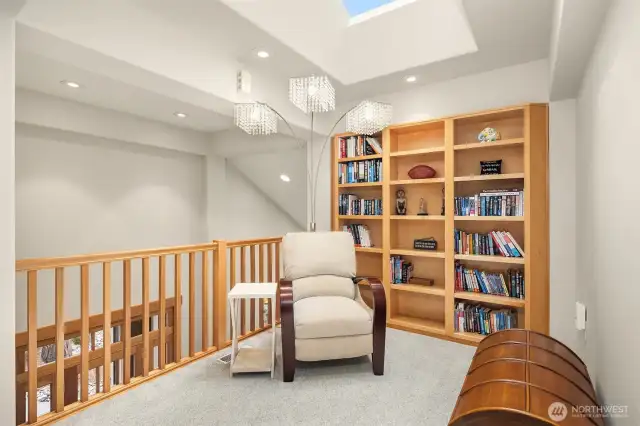 Enter the upper-level to newer carpeting and a sunlit loft/library with built-in bookcases which could serve as a second office space.