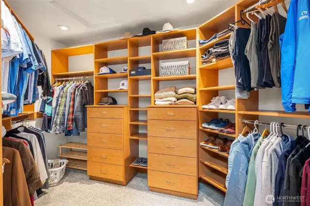 The large primary bedroom walk-in closet features California Closet built-ins.