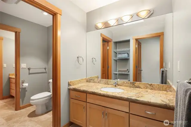 The Jack & Jill bathroom features granite counter vanities bridged by the full tub/shower, toilet room and tile floors.