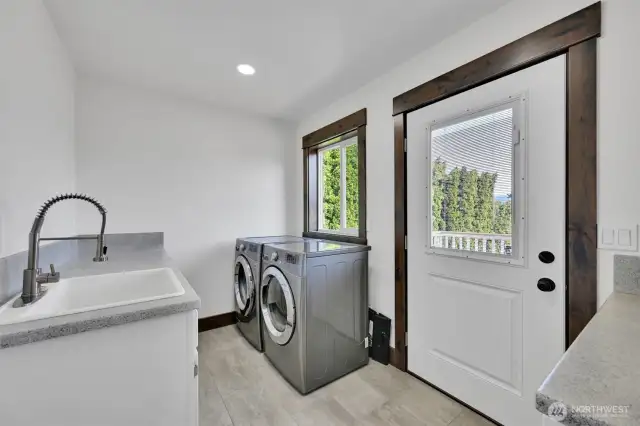 laundry room with cabinets and sink