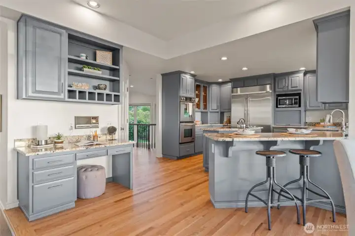 Kitchen with center island, breakfast bar, stainless appliances.