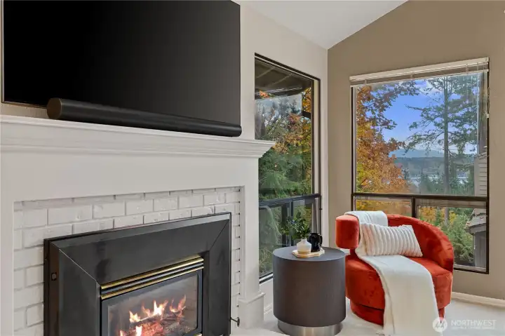 Cozy gas fireplace with a lake view