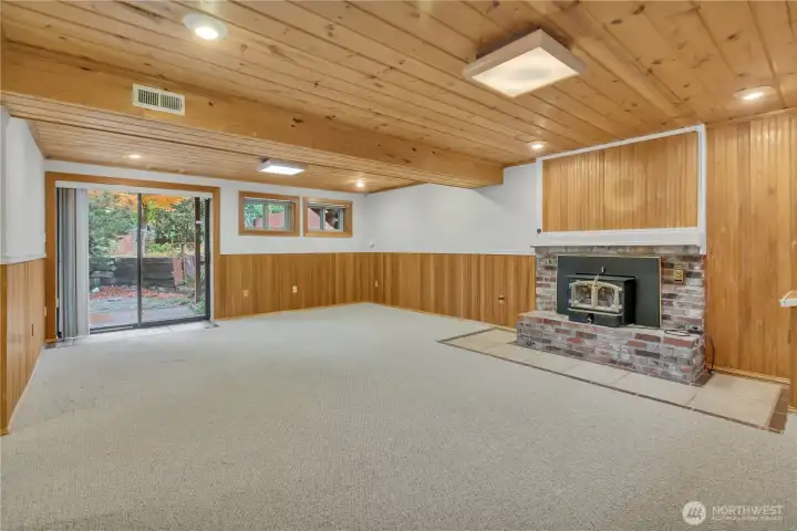 Lower Level Family/Bonus room feautres wood fireplace and access to the backyard