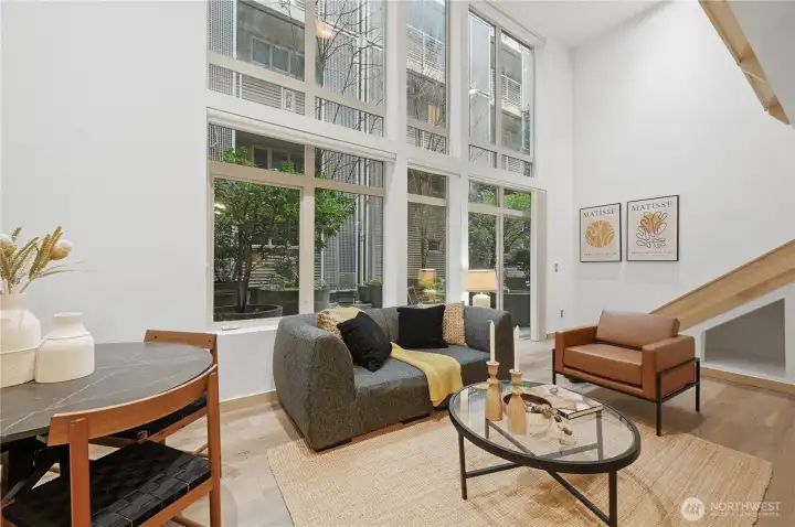 Soaring ceilings from this fabulous two-story loft style home with west facing patio drenched in natural light!