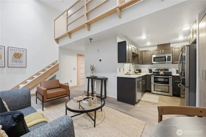 Main living area leads to your new recently renovated kitchen with new cabinetry & slab quartz countertops plus stainless steel appliances.