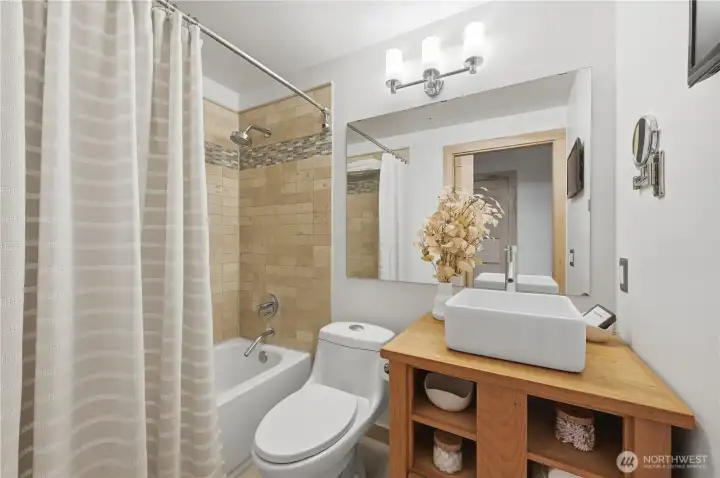Awesome tile full bath with cool wood vanity.