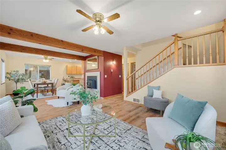 Living room, wood stove, stairs going up.