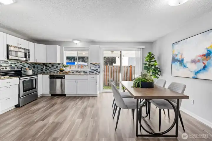 Down the hallway leads you to this delightful open kitchen and dining nook.