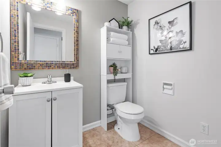 Right off the living room is the updated modern powder room.