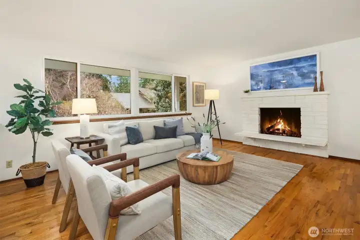 Spacious living room with a cozy fireplace, abundant natural light, and flexible space to relax, gather, or reimagine over time.