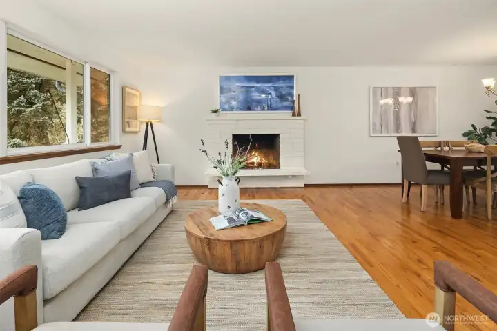 Inviting main living area with hardwood floors, fireplace, and oversized windows—warm, welcoming, and easy to make your own.