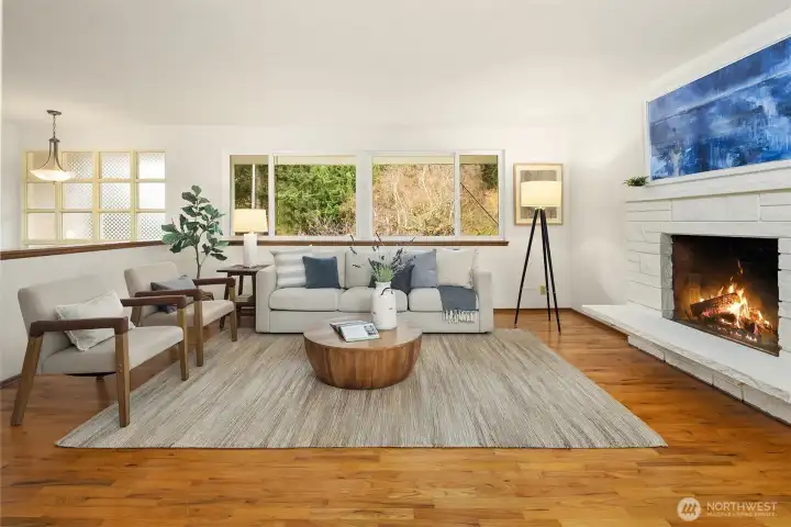 Bright and comfortable living space with a wide picture window overlooking greenery, offering a peaceful setting with room to personalize.