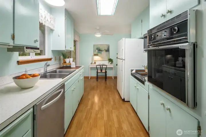 Adorable kitchen with cheerful cabinetry, generous storage, and a layout ready for personalization and future enhancements.