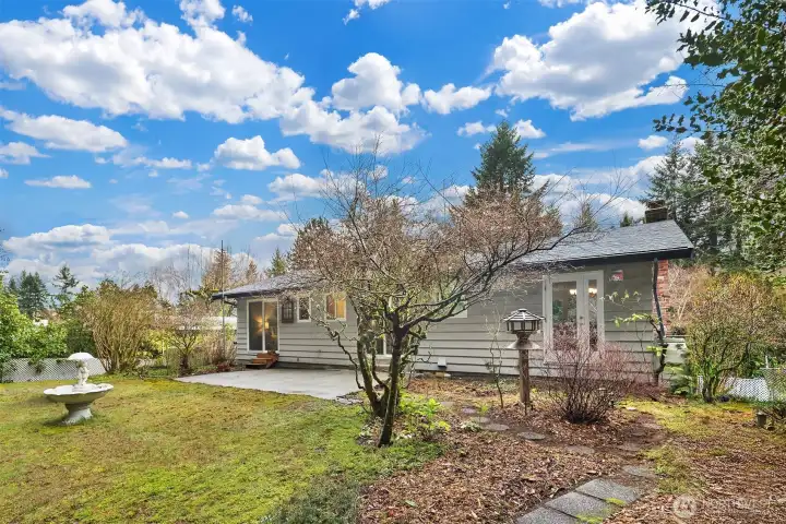 Established plantings and garden elements add charm and texture to the outdoor spaces.