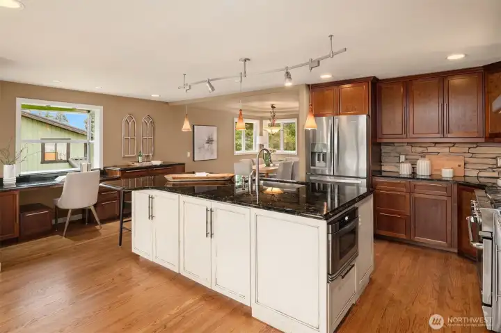 Gourmet kitchen with a huge Italian granite island and bar seating.