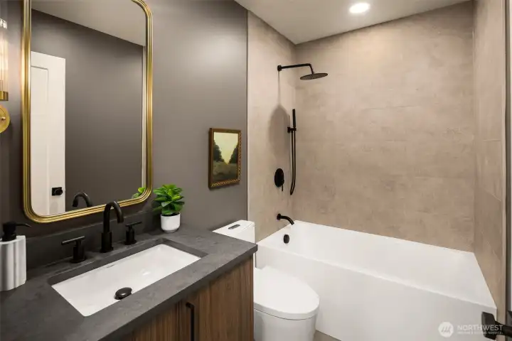 A full sized tub with a two showerhead arrangement- featuring a lighter finish