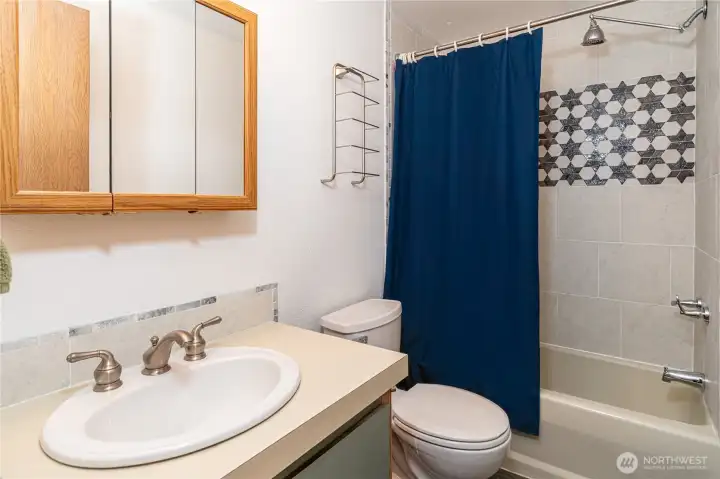 Full bath with new tile surround.