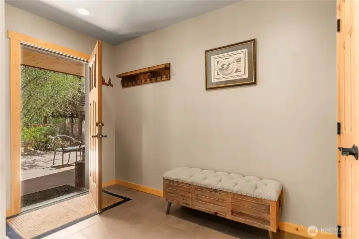 Main entry with wide hall looking towards covered seating area directly outside