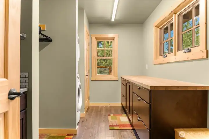 Main laundry, complete with sink, storage, built ins and more.