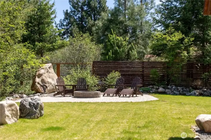 One of many perfectly nestled conversation areas to enjoy the immaculate yard and natural textures