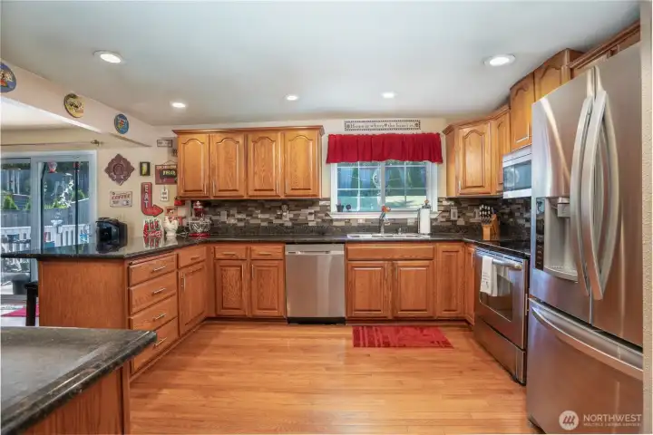 More than one cook in your home?  No problem!  This kitchen is huge and features a stainless steel appliance package, hardwood floors, granite counters, and tile backsplash.