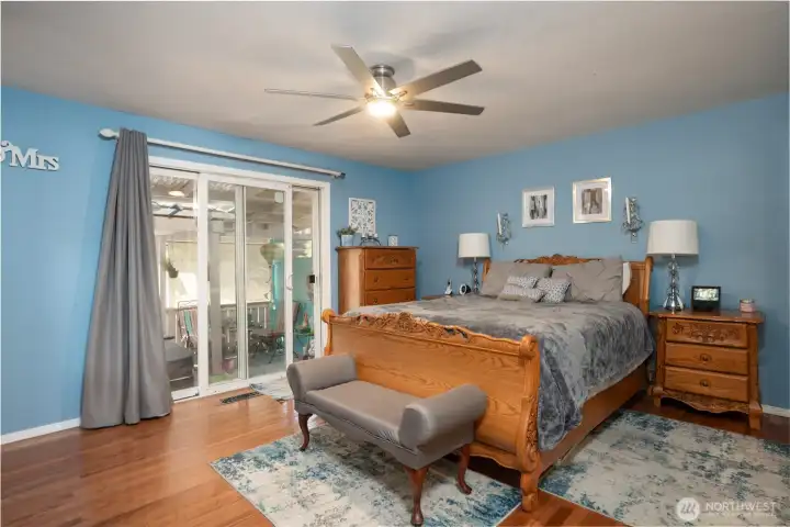 A sliding glass door  leads to an uber private covered patio area with hot tub.