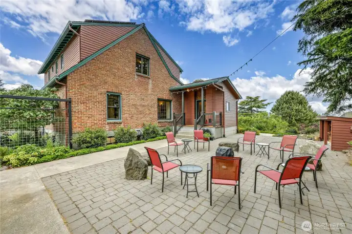 Fully fenced back yard encloses this private patio and fire pit.