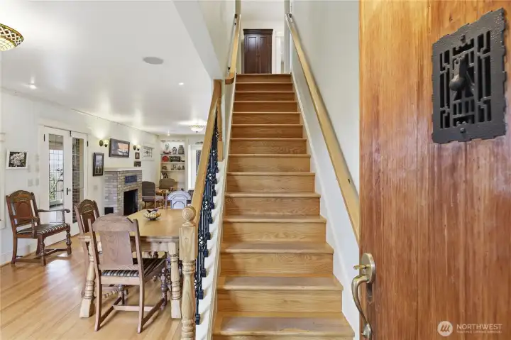 Entering into the open dining living room area.  Notice the beautiful beech wood floors in this open floor plan.  The oak stairs head up to the second floor.