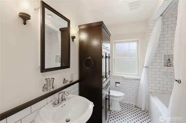 Full bath on the main floor between the 2 bedrooms. Tile shower and tile floor.