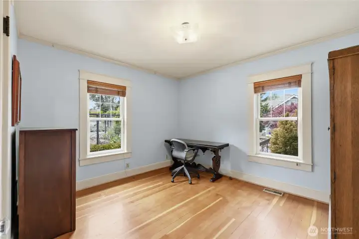 Main floor second bedroom facing the front gardens and the vegetable garden. Clear Vertical Grain  Fir wood floors.