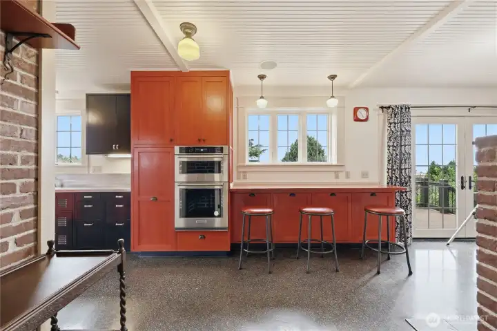 Enter the kitchen with a breakfast bar that views the garden and watch the sunrise over the mts, bay and city.  Class doors are to the a large deck.  Mircowave and oven convently located.