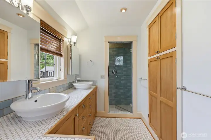 Primary bath with walk in tile shower, double sinks and lots of storage.